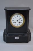 A LATE 19TH CENTURY CONTINENTAL BLACK SLATE MANTEL CLOCK, plain case with moulded detail, white