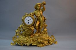 A LATE 19TH CENTURY FRENCH GILT METAL THIRTY HOUR MANTEL CLOCK, cast with a boy holding grapes aloft