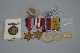 A PLASTIC BOX CONTAINING A NUMBER OF MEDALS AND BADGES, to include WWII 1939-45 and France and