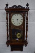 A LATE 19TH CENTURY WALNUT CASED WALL CLOCK, eight day movement, turned finials and arched