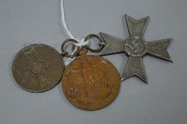 A GROUP OF THREE MILITARY MEDALS, consisting a WW2 German War Merit Cross, no ribbon, dated 1939,