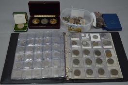 A CASE CONTAINING COIN AND RELATED ITEMS, to include a 20th Century album of coins, a cased three