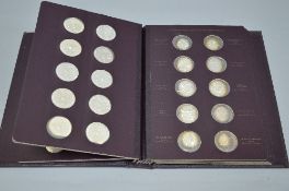 AN ALBUM CONTAINING SIXTY PROOF MEDALLIONS, most with toning in protective capsules, 1970 by The