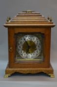 A MID 20TH CENTURY GERMAN OAK CASE BRACKET CLOCK, stepped caddy top with carrying handle,