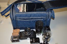 A SOFT CAMERA CASE WITH A MIRANDA SENSOMAT RE SLR, two extra viewing heads, a 135mm 1:2.8 lens, a