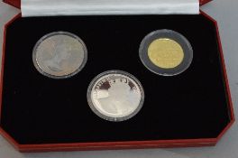 A HALF OUNCE GOLD COIN, together with sterling silver and Titanium coin in an Isle of Man, Past,