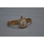 A 9CT GOLD LADIES WRISTWATCH, movement stamped Breguet, on a 9ct expandable strap