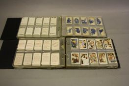 TWO ALBUMS OF CIGARETTE CARDS, comprising predominantly full sets with a small number of part