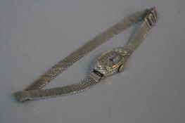 AN EARLY 20TH CENTURY DIAMOND COCKTAIL WATCH, Tonneau shaped case measuring approximately 23mm x