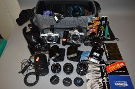 A CAMERA BAG CONTAINING OLYMPUS CAMERA EQUIPMENT, two Olympus OM1 MD SLR's, two OM winder 2.2 T20