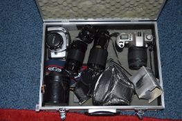 AN ALUMINIUM CASE WITH CANON CAMERAS AND ACCESSORIES, these include an EOS 500N fitted with a