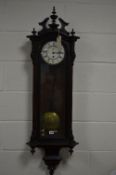 A LATE 19TH CENTURY WALNUT AND EBONISED THIRTY HOUR WALL CLOCK, broken swan neck pediment with three