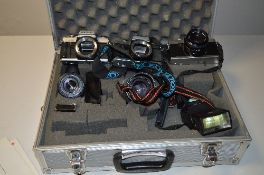 AN ALUMINIUM CAMERA CASE WITH THREE MINOLTA CAMERAS AND LENSES, these are an X-300, XG-1 and another