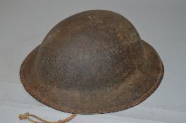 A WWI ERA BRITISH INFANTRY HELMET, marked to underside 'HS' the helmet retains its inner liner