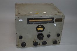 A WWII ERA BRITISH POSSIBLY RADIO RECEIVER, large oblong with various