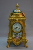 A LATE 19TH CENTURY FRENCH GILT METAL MANTEL CLOCK OF RECTANGULAR FORM, pineapple finial above a
