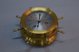 A SCHATZ OF WEST GERMANY 'SHIPS BELL' EIGHT DAY BRASS WALL CLOCK, ship's wheel form, gong strike,