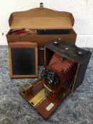 A ROCHESTER OPTICAL AND CAMERA COMPANY CYCLE POGO NO.5 FOLDING CAMERA, with mahogany case covered in