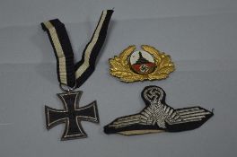 A WWI IMPERIAL GERMANY IRON CROSS WITH RIBBON, believed one piece construction, also a WWII Eagle