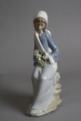A LLADRO FIGURE, girl with Lilies, seated, No 4972