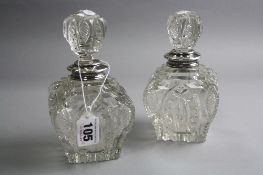 A PAIR OF SILVER TOPPED BOTTLES (sd to necks) (sold on behalf of St Giles Hospice)