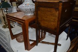 A TEAK G PLAN NEST OF THREE TABLES, pine two door bookcase, an oak sewing box, two footstools and