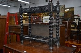 A DARK CARVED OAK UMBRELLA STAND (missing tray inserts)