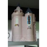 A PINK PLASTIC TOY CASTLE, opens to reveal interior, approximate height 59cm