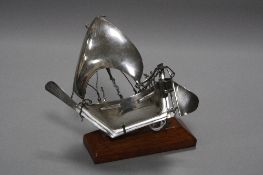 A 20TH CENTURY WHITE METAL MODEL OF A BOAT, on a wooden stand, height 10.5cm (situated in