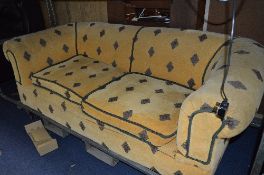 A REUPHOLSTERED CHESTERFIELD SOFA, with Georgian style tapered block legs with brass and ceramic