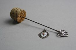 A SILVER STICK PIN AND A SILVER ENAMEL PENDANT, both by Charles Horner