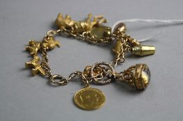 A MIXED 9CT AND YELLOW METAL CHARM BRACELET, to include a 1903 half sovereign