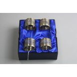 A BOXED SET OF FOUR SILVER NAPKIN RINGS, approximate weight 89grams