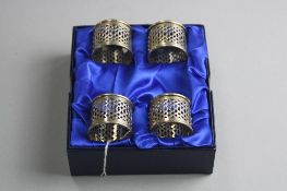 A BOXED SET OF FOUR SILVER NAPKIN RINGS, approximate weight 89grams