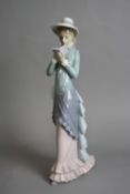 A LLADRO FIGURE, of a young lady reading a book, approximate height 36cm