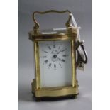 A BRASS CARRIAGE CLOCK, serpentine design, 'L'Epee France', approximate height 11.5cm (key)