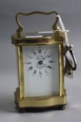 A BRASS CARRIAGE CLOCK, serpentine design, 'L'Epee France', approximate height 11.5cm (key)