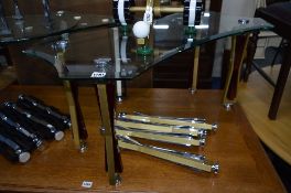 A GLASS TOPPED COFFEE TABLE, on modern contemporary legs and four similar spare legs (5)