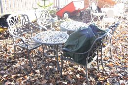 TWO ROUND METAL GARDEN TABLES, and four metal garden chairs (6)