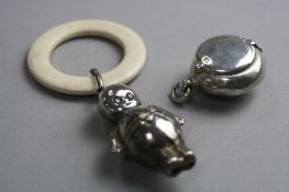 A SILVER TEETHING RATTLE, Chester 1893 and a Wilcox Pat sovereign case Birmingham 1904