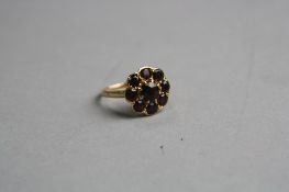 A 9CT FLOWER GARNET RING, ring size M, approximate weight 3.6 grams