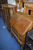 AN OAK BUREAU, (key) and a walnut china cabinet (key) (2)