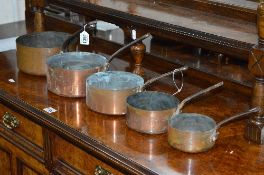 A SET OF FIVE GRADUATING COPPER SAUCEPANS