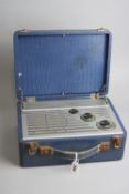 A VINTAGE PORTABLE PYE RADIO, in a blue faux crocodile skin case, hinged lid, width 20cm x depth