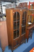 TALL OAK GLAZED TWO DOOR BOOKCASE (KEY)