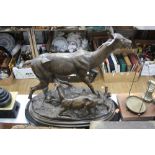 A 20TH CENTURY BRONZE FIGURE GROUP OF A DOE AND FAWN, the fawn in the motion of kneeling to
