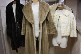 TWO WHITE FUR EVENING JACKETS, one with label 'Goodkind of Mayfair', together with two long coats,