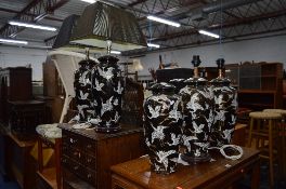 FIVE ORIENTAL CERAMIC LAMPS, and bases with crane designs over black and gold ground (one missing