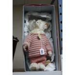 A MODERN STEIFF 1907 REPLICA CLASSIC MOHAIR TEDDY BEAR, (027567), pink woollen suit and cap,
