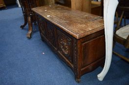 A CARVED OAK BLANKET CHEST, with triple panels